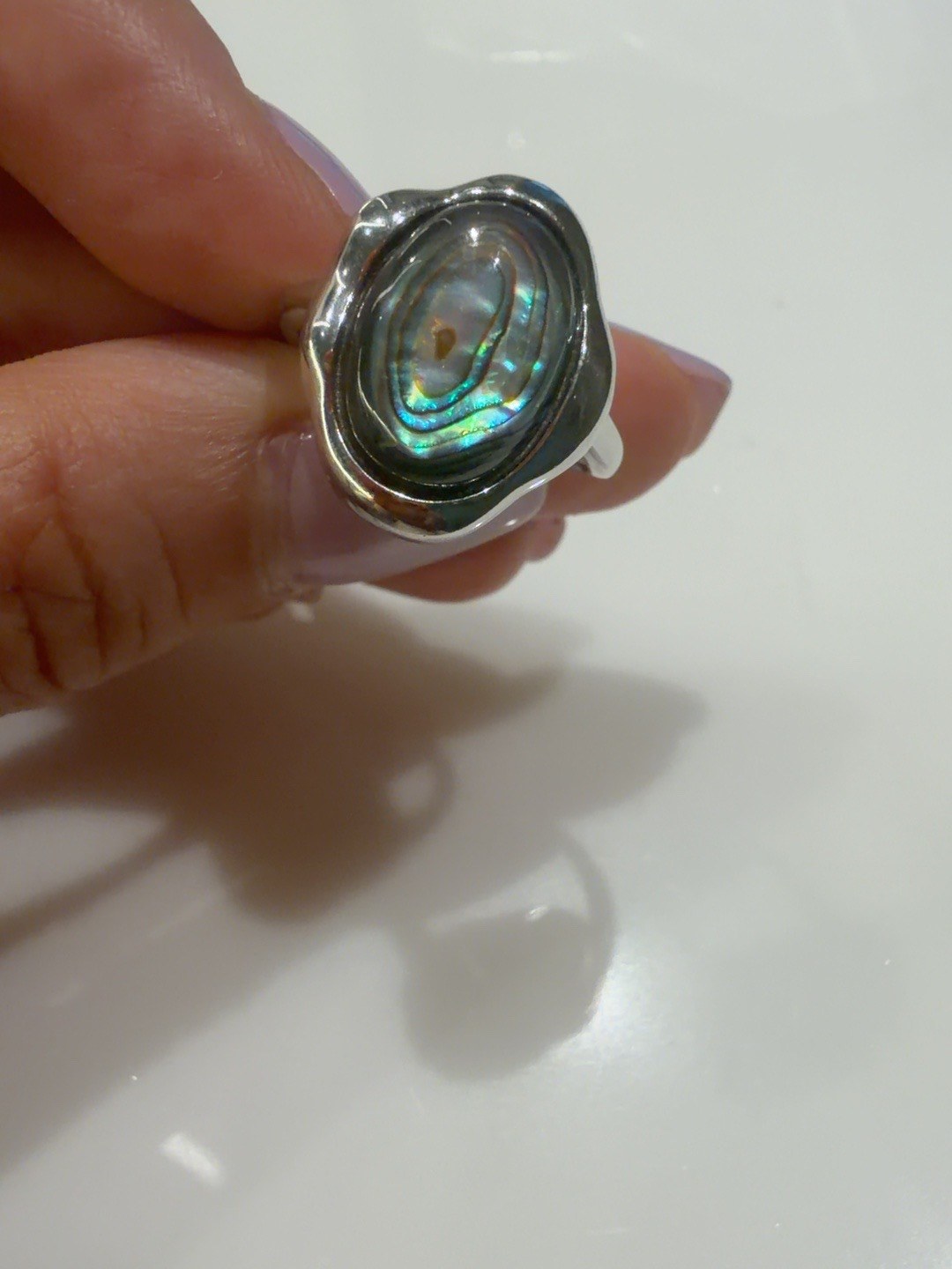 Iridescent abalone shell ring with an organic silver frame
