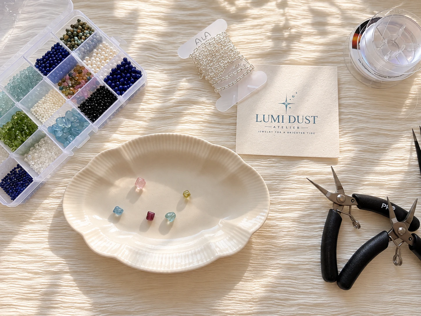 Lumi Dust jewelry design workspace with natural gemstones, pearls and jewelry-making materials.