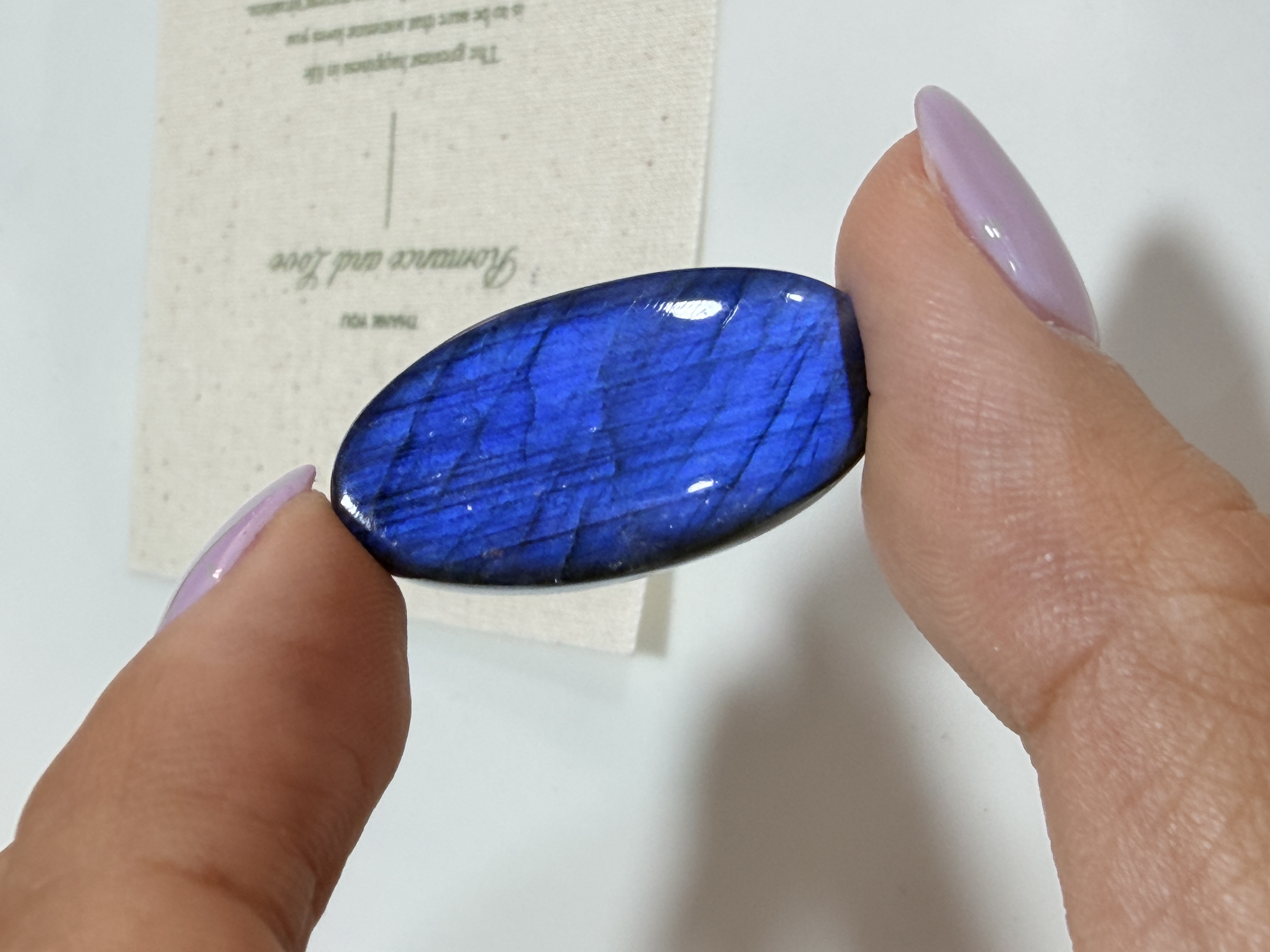 Natural blue-flash labradorite held in hand