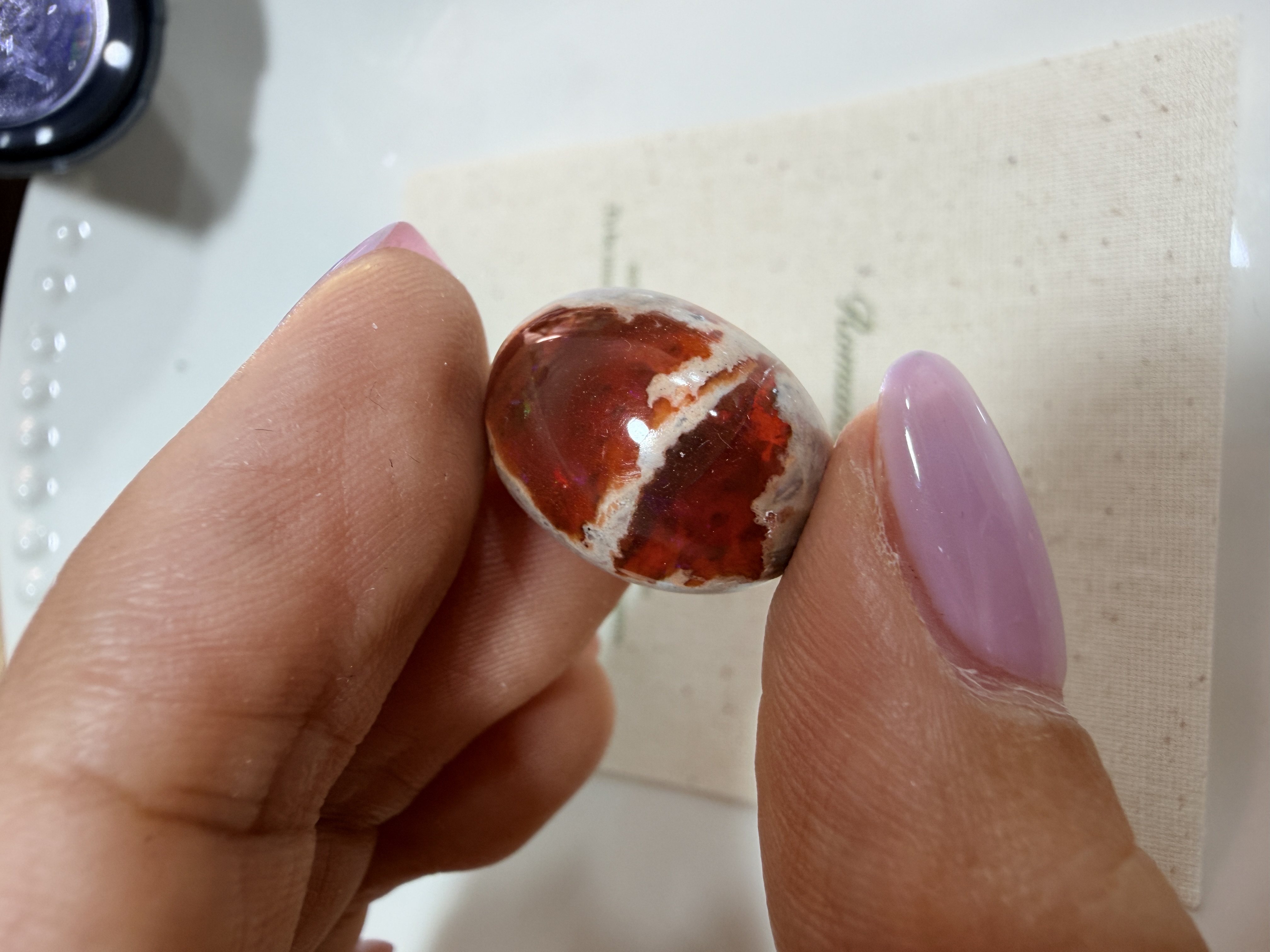 Natural opal material held in light